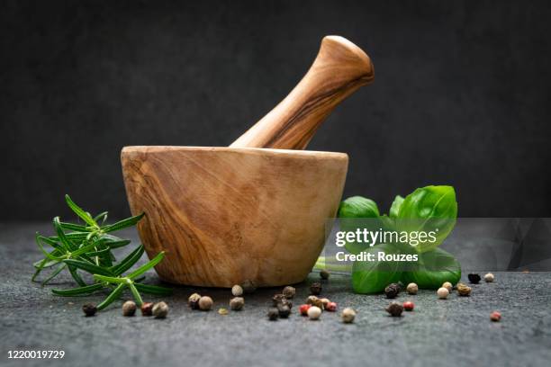 mortar and pastle with fresh herbs for cooking - mortar and pestle stock pictures, royalty-free photos & images