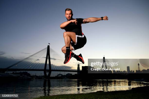 Dancer, instructor and musical theatre performer Heath Keating performs a dance manoeuvre on the shoreline at Blackwattle Bay on April 21, 2020 in...