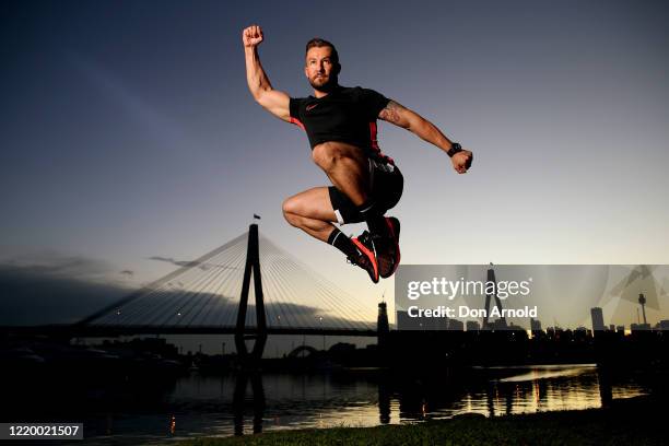 Dancer, instructor and musical theatre performer Heath Keating performs a dance manoeuvre on the shoreline at Blackwattle Bay on April 21, 2020 in...