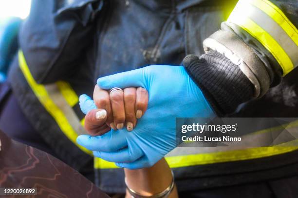 helping hand - red glove stockfoto's en -beelden