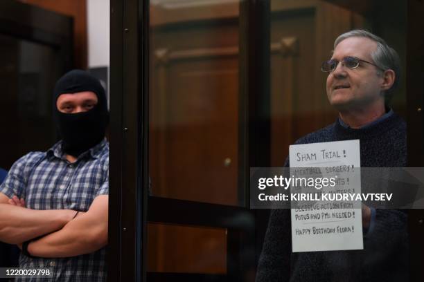 Paul Whelan, a former US marine accused of espionage and arrested in Russia in December 2018, stands inside a defendants' cage as he waits to hear...