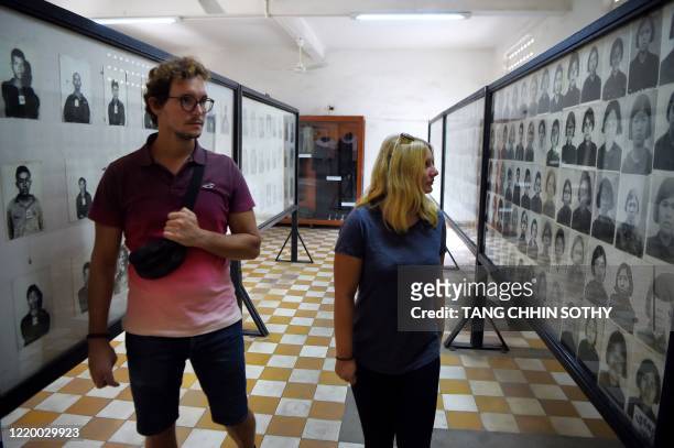 Tourists visit the reopened Tuol Sleng genocide museum in Phnom Penh on June 15, 2020 displaying mugshots of Khmer Rouge torture victims. - The...