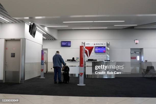 Passenger waits to board a Baltimore, Maryland bound Delta flight from Hartsfield-Jackson Atlanta International Airport on April 20, 2020 in Atlanta,...