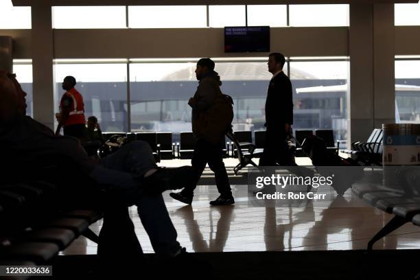 Travelers walk through terminal A at Hartsfield-Jackson Atlanta International Airport on April 20, 2020 in Atlanta, Georgia. The airline industry has...