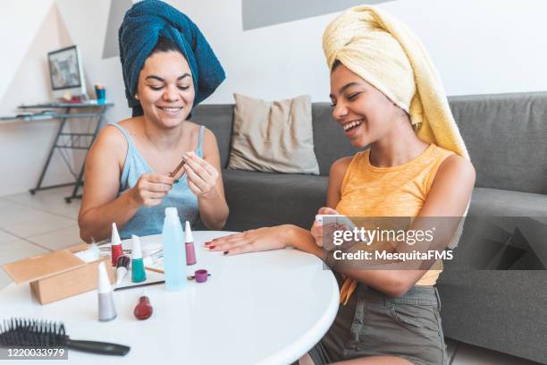 mother and daughter doing manicure at home - girls' night in stock pictures, royalty-free photos & images