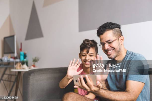 family communicating by video conference - friends waving stock pictures, royalty-free photos & images