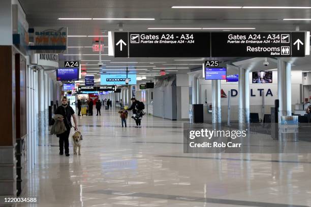 Travelers walk through terminal A at Hartsfield-Jackson Atlanta International Airport on April 20, 2020 in Atlanta, Georgia. The airline industry has...