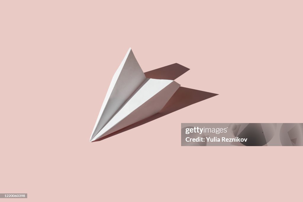 Paper airplane on the pink background