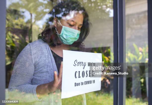 asian entrepreneur closing business due to covid 19 outbreak - lockdown stock pictures, royalty-free photos & images