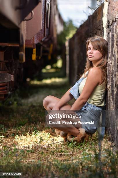 summer fashion female portrait of young beautiful girl near old train on train station - cross railway station stock pictures, royalty-free photos & images