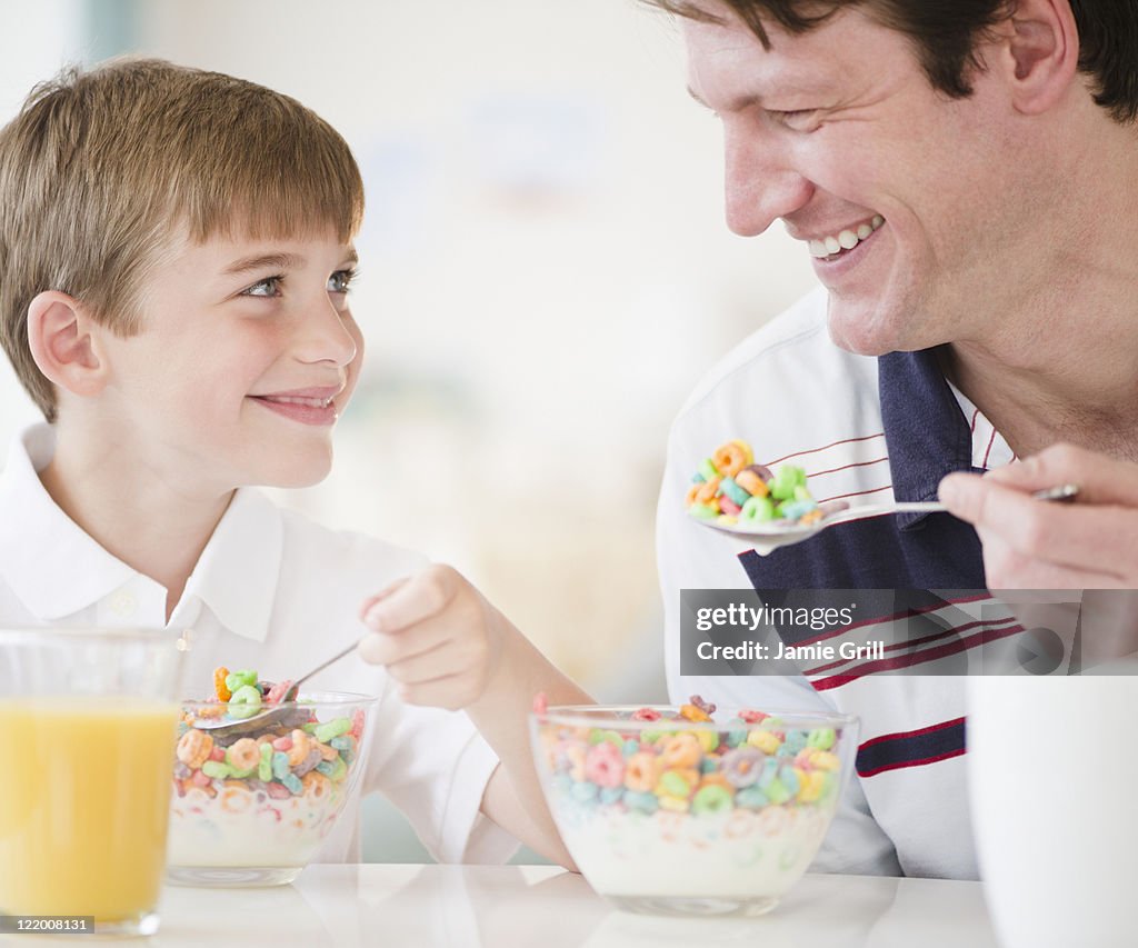 Father and son eating cereal together