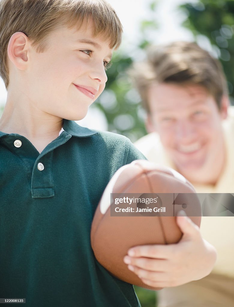 Father and son playing football