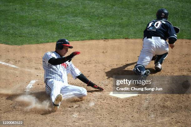 Kim Ho-eun of LG Twins slides safely into the home plate during the preseason game between LG Twins and Doosan Bears at Jamsil Baseball Stadium on...