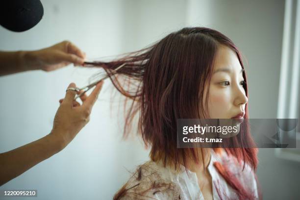 woman cutting hair dyed red - short hair cut stock pictures, royalty-free photos & images