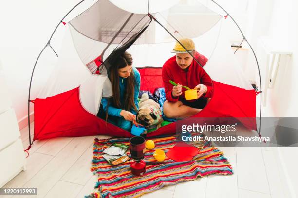 family have a great camping time staying home during quarantine - inside of tent stock pictures, royalty-free photos & images