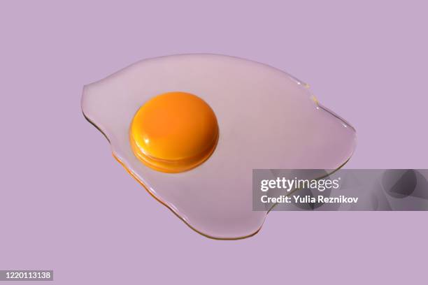 raw egg on the purple background - gema de ovo imagens e fotografias de stock