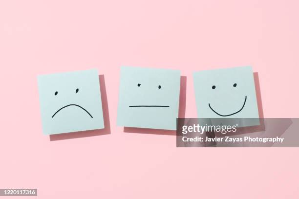 three blue sticky blank notes on pink background - happiness concept stockfoto's en -beelden