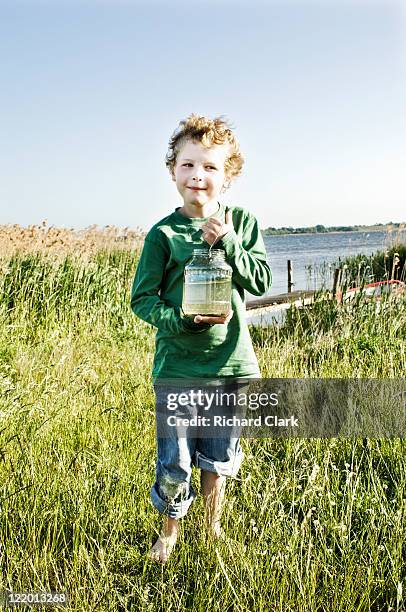 young boy fishing - ffi feature stock pictures, royalty-free photos & images