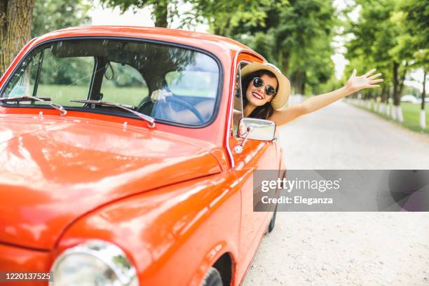 frau und ihr oldtimer und winken - auto cool stock-fotos und bilder