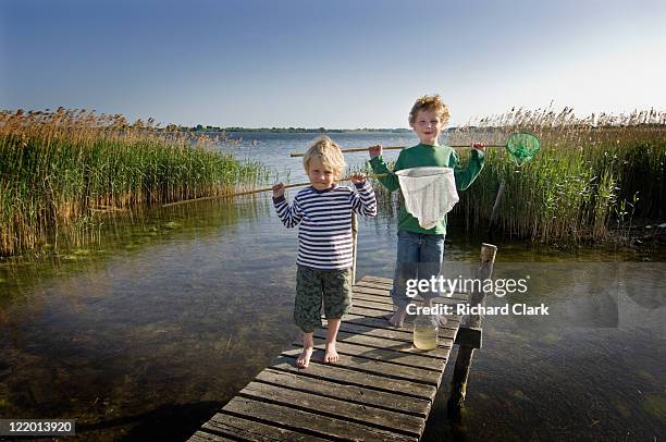 two young boys fishing - ffi feature stock pictures, royalty-free photos & images