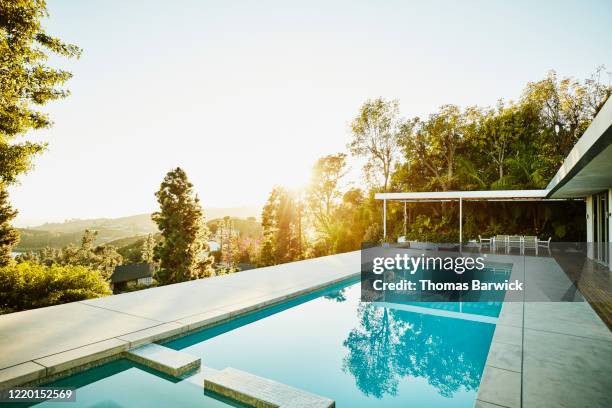 pool in backyard of modern house at sunset - backyard deck stock pictures, royalty-free photos & images