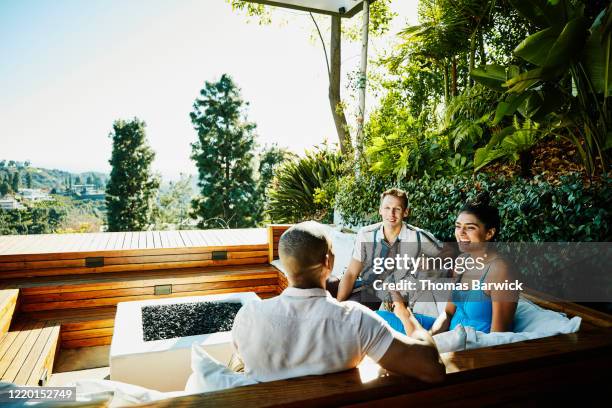 group of friends relaxing in backyard - indio california fotografías e imágenes de stock