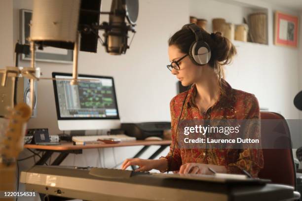 home studio player woman - woman in guitar making studio stock pictures, royalty-free photos & images