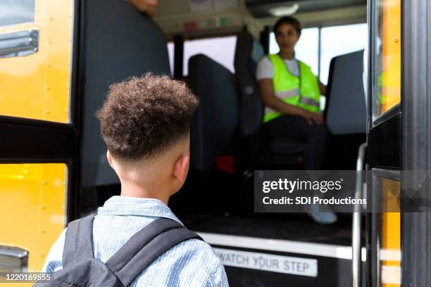 school boy boards school bus - back of heads stock pictures, royalty-free photos & images