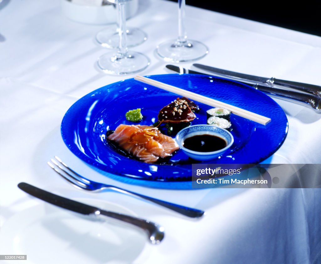 Sushi & sashimi on plate, restaurant table setting