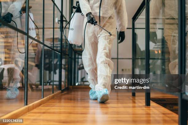 office disinfection during covid-19 pandemic,stopping the spread of the virus - workplace danger stock pictures, royalty-free photos & images