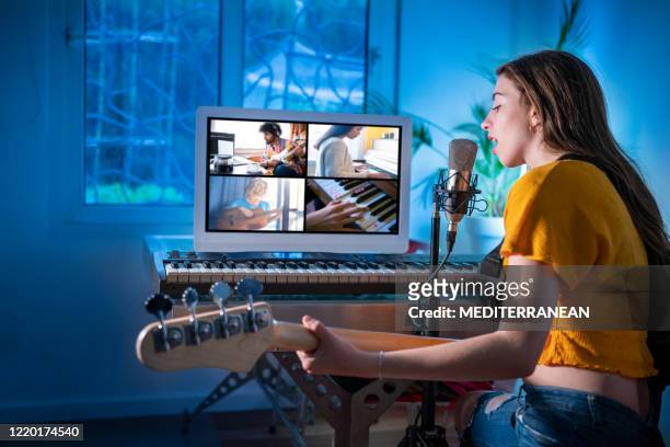 brunette teen musician singer girl singing and playing bass guitar teleconference - musician stock pictures, royalty-free photos & images