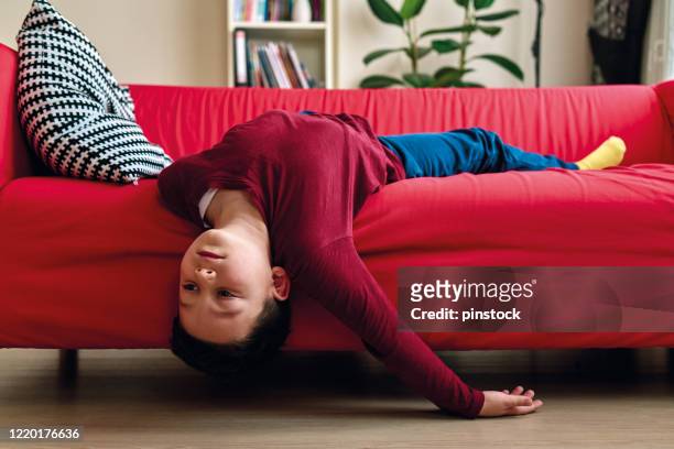 bored child on living room. - bores stock pictures, royalty-free photos & images