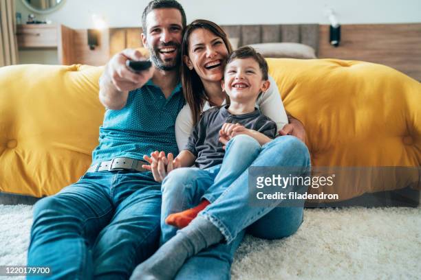 tiempo de televisión con la familia - familia viendo television fotografías e imágenes de stock