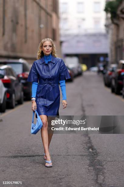 Leonie Hanne wears a blue leather dress, a blue turtleneck pullover, a blue bag, blue sandals, outside Sportmax, during Milan Fashion Week...