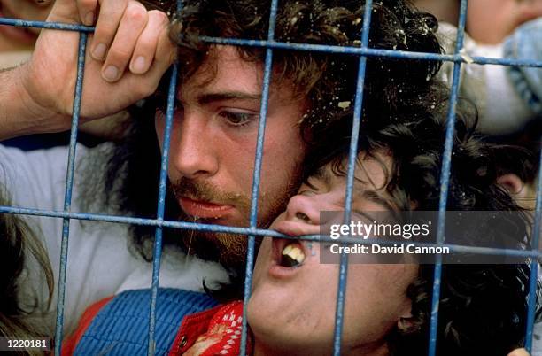 Supporters are crushed against the barrier as disaster strikes before the FA Cup semi-final match between Liverpool and Nottingham Forest played at...