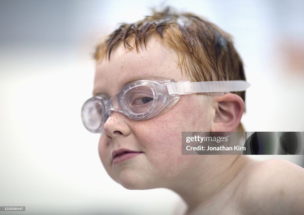 Young boy has sly look at a swim meet.