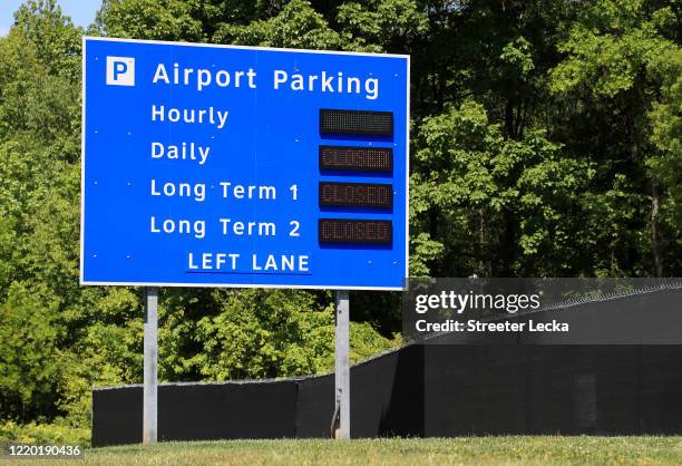 Signs along empty roads, showing closed parking lots, at Charlotte Douglas International Airport during the coronavirus pandemic on April 21, 2020 in...