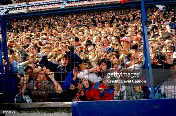 Supporters are crushed against the barrier as disaster strikes before the FA Cup semi-final match between Liverpool and Nottingham Forest played at...