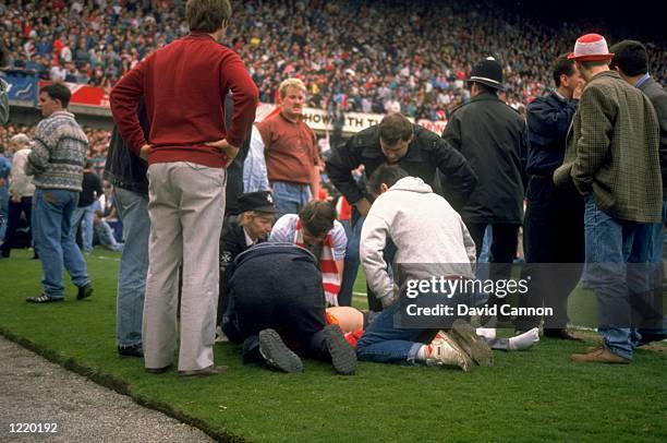 Supporters are crushed against the barrier as disaster strikes before the FA Cup semi-final match between Liverpool and Nottingham Forest played at...