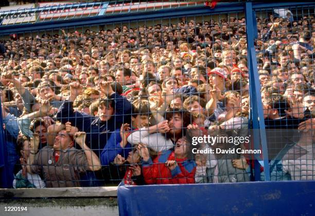 Supporters are crushed against the barrier as disaster strikes before the FA Cup semi-final match between Liverpool and Nottingham Forest played at...