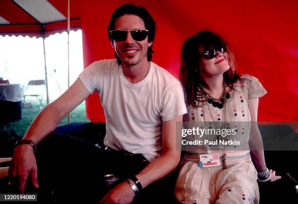 Portrait of American Punk and Rock musicians John Doe and Exene Cervenka, both of the group X, as they sit backstage during the Farm Aid 2 benefit...