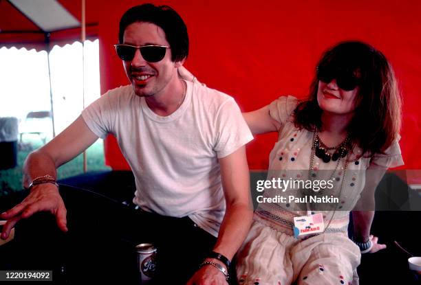 Portrait of American Punk and Rock musicians John Doe and Exene Cervenka, both of the group X, as they sit backstage during the Farm Aid 2 benefit...