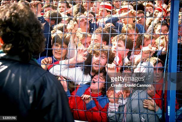 Supporters are crushed against the barrier as disaster strikes before the FA Cup semi-final match between Liverpool and Nottingham Forest played at...