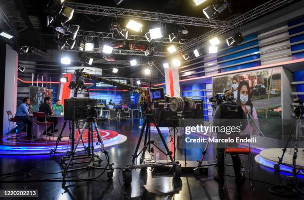 Cameraman wearing face mask and journalist work at Cronica Television on April 15, 2020 in Buenos Aires, Argentina.