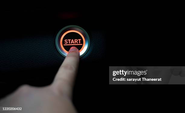 the fingers are pressing the start push button. startup concept. - eröffnung stock-fotos und bilder