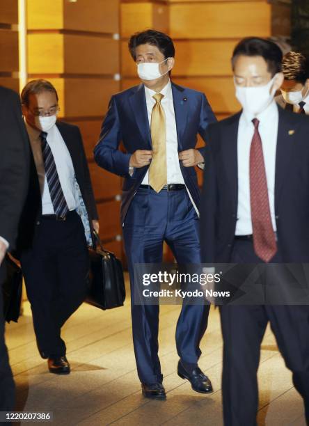 Japanese Prime Minister Shinzo Abe leaves his office in Tokyo on June 15, 2020. Japan announced earlier in the day that it will halt the process of...