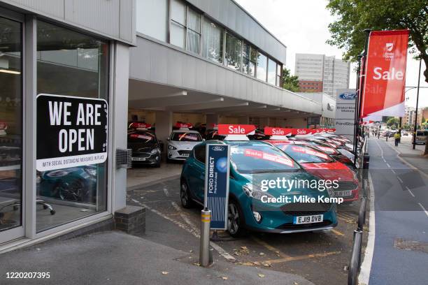 As the Coronavirus lockdown measures ease, this car dealership announces that 'we are open' for business on 15th June 2020 in Birmingham, England,...