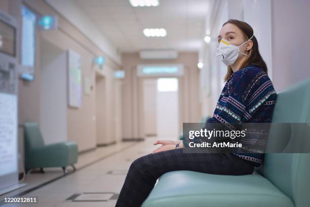 young girl wearing protective mask in medical clinic - waiting room clinic stock pictures, royalty-free photos & images