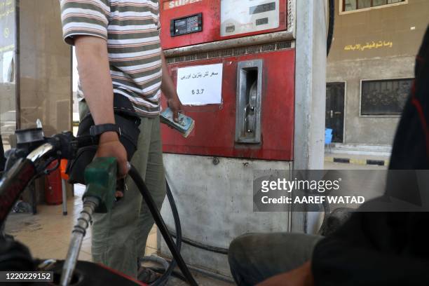 Gasoline prices are displayed in Turkish lira at a gas station in the town of Sarmada in Syria's northwestern Idlib province, on June 15, 2020. -...