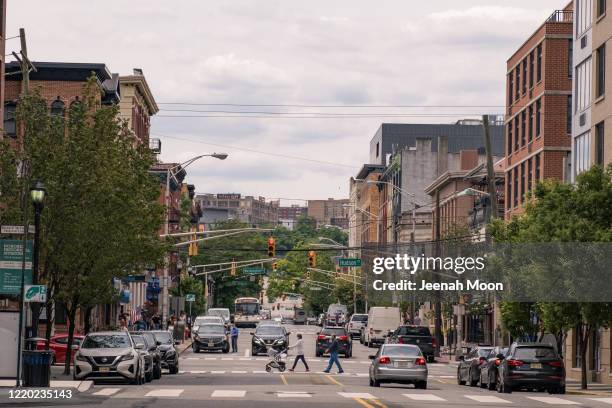 People wearing the protective mask walk on the street as the city reopens from the coronavirus lockdown on June 15, 2020 in Hoboken, New Jersey. The...